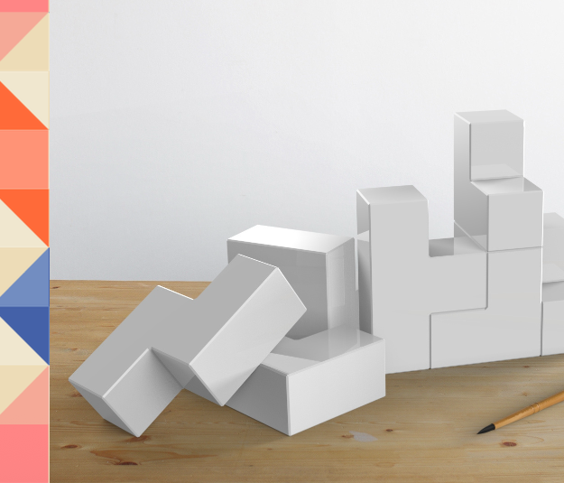 The Anchor blocks arranged loosely on a wooden table, some stacked and some scattered, showing the range of configurations the form allows.